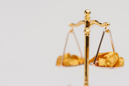Beautiful Golden Balance Scales with little pieces of gold. Gold cost climbing up. Finance, gold...