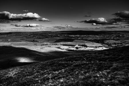 Scenic view from Pendle Hill, East, Clouds cast shadows over Lancashire Hills. Black and white....