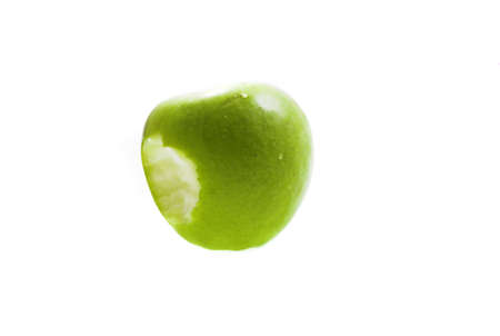 eating green apple on white backgroundの写真素材