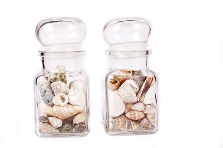small shells in jar on white backgroundの写真素材