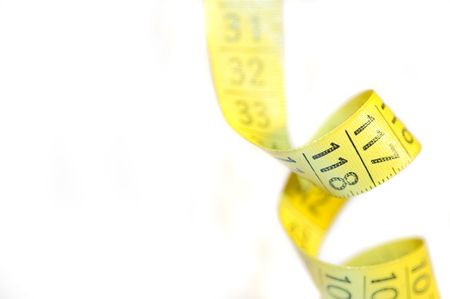 a yellow centimeter measure on white background の写真素材