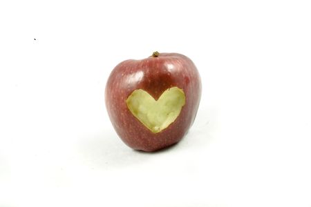 red autumn apple in heart on white backgroundの写真素材