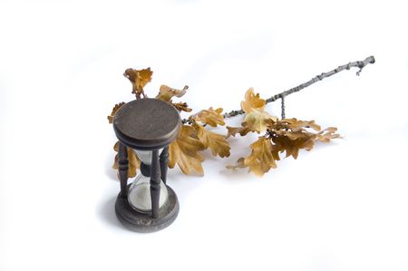 sand-glass and fall oak on white background の写真素材