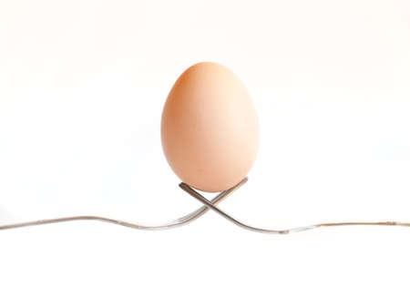 Easter egg kept on the cutlery on a white egg, Easter,  white, isolated  background, celebrateの写真素材