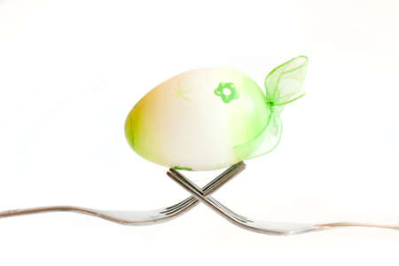 Easter egg kept on the cutlery on a white egg, Easter,  white, isolated  background, celebrateの写真素材