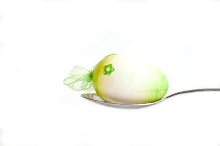 Easter egg kept on the cutlery on a white egg, Easter,  white, isolated  background, celebrateの写真素材