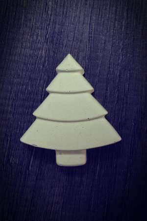 Gypsum Decorative Christmas tree on a dark wooden backgroundの写真素材