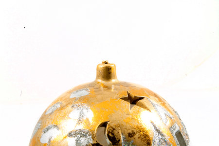 shiny gold hand-painted Christmas bauble on a white backgroundの写真素材