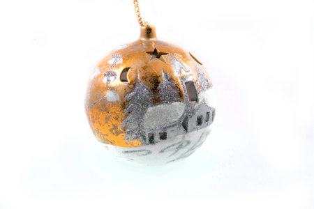 shiny gold hand-painted Christmas bauble on a white backgroundの写真素材