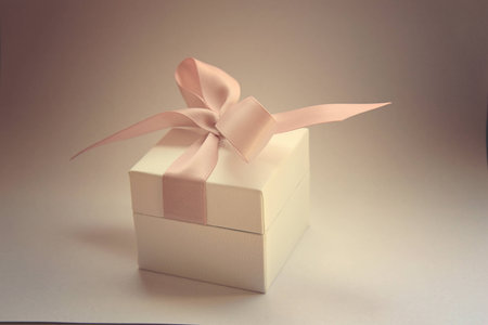 gift in a white box with a pink bow