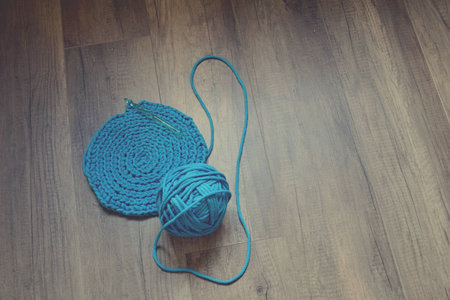 Blue crochet knitting manual pad on the table hand knitting,の写真素材