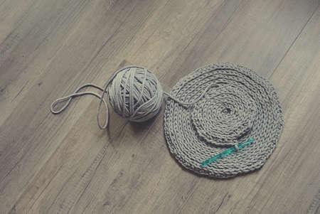 grey handmade cotton cord tablecloths on crochet hookの写真素材