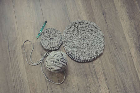 grey handmade cotton cord tablecloths on crochet hookの写真素材