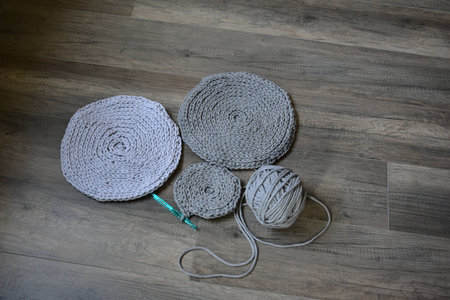 grey handmade cotton cord tablecloths on crochet hookの写真素材