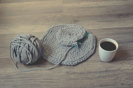 grey handmade cotto ncord tablecloths on crochet hook with coffeeの写真素材