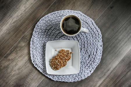 grey handmade cotto ncord tablecloths on crochet hook with coffeeの写真素材