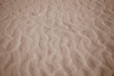 nice beige background with sand in the shape of sand wavesの写真素材