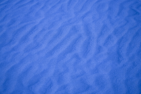 nice blue background with sand in the shape of sand wavesの写真素材