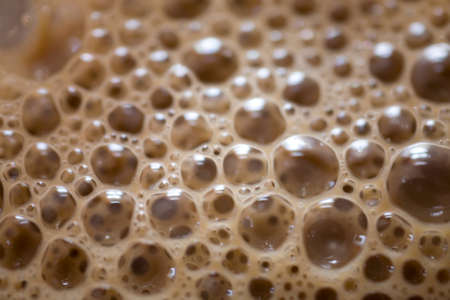 Interesting background of beige coffee foam in closeupの写真素材