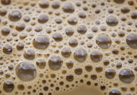 Interesting background of beige coffee foam in closeupの写真素材