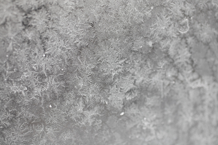 original beautiful background with a pattern painted by frost on the window glass