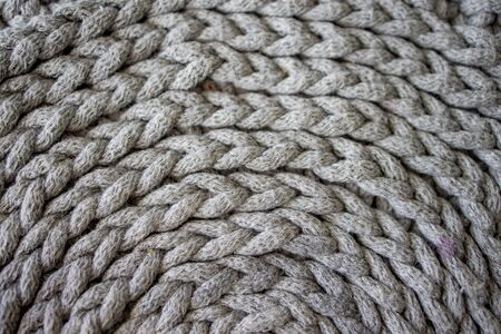 beautiful interesting background made of crochet hand-made, gray cotton cordの写真素材