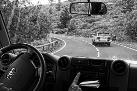 large white off-road cars traveling on the roads around the Teide volcano on the Spanish Canary...