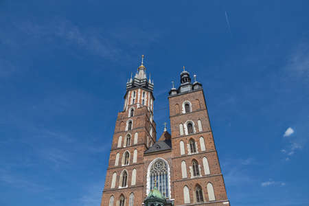 famous historic church in the old town square in krakow, poland on a summer holiday dayの写真素材