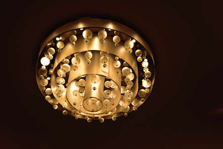 an interesting abstract background with an original glowing chandelier on the ceiling