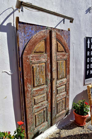 beautiful wooden door in the historic greek town of Lindos in Greece on a holiday dayの写真素材