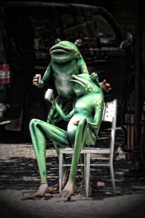 funny statue of green frogs drinking turkish tea in the cityの写真素材