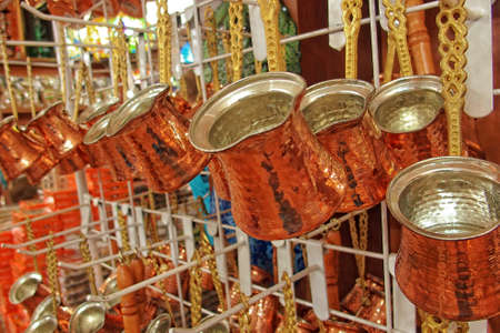 beautiful small elegant copper turkish coffee pots in the shop on displayの写真素材