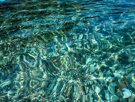 beautiful interesting background with clear sea water shining in the sun