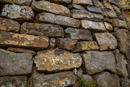 beautiful wall background with an old ancient stone structure close-upの写真素材