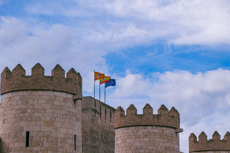 three european union and aragon spain flags against the sky on a stone historic castleのeditorial素材