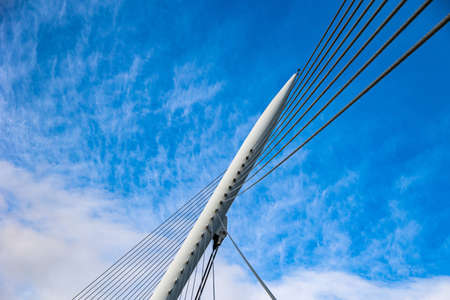 beautiful pedestrian suspension bridge over the Ebro river in Zaragoza, Spain on a summer dayの写真素材