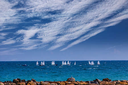 beautiful calm blue seaside landscape with water and sky and sailboats