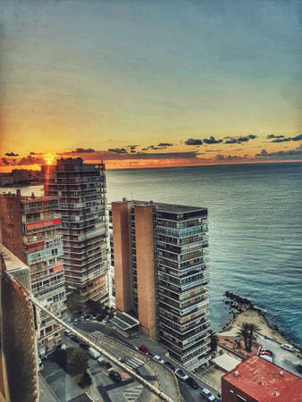 beautiful seaside landscape of alicante spain with sea and skyscrapers on a sunny dayの写真素材