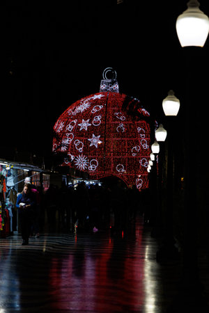 beautiful big glowing red bauble Christmas decoration in Alicante, Spain at nightの写真素材