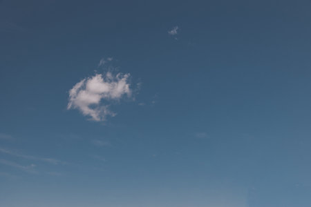 beautiful background small white summer cloud against the blue sky minimalistic landscapeの写真素材