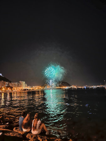 beautiful colorful fireworks in the night sky on the seafront of Alicante spainの写真素材