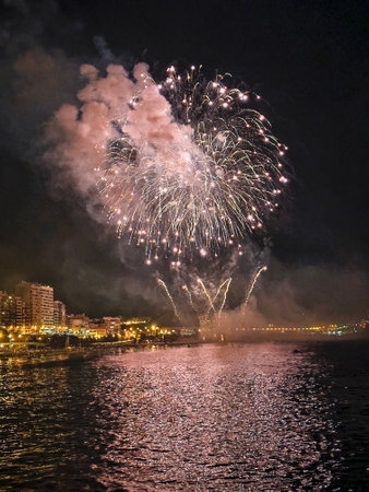 beautiful colorful fireworks in the night sky on the seafront of Alicante spainの写真素材