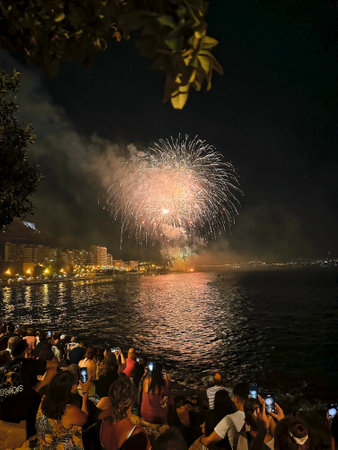 beautiful colorful fireworks in the night sky on the seafront of Alicante spainの写真素材