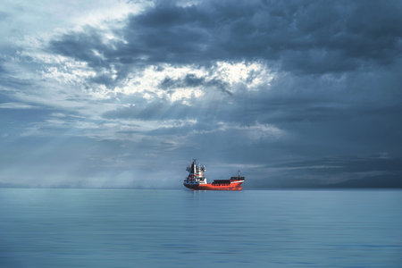 red cargo ship in the blue sea calm minimalist landscapeの写真素材