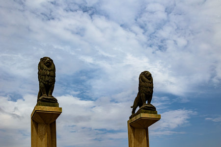 beautiful vintage lions on a stone bridge in Zaragoza Spain against the skyの写真素材