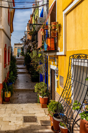beautiful historic old colorful houses Barrio Santa Cruz Alicante Spain on a sunny dayの写真素材