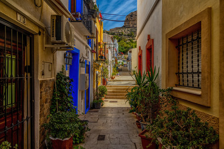 beautiful historic old colorful houses Barrio Santa Cruz Alicante Spain on a sunny dayの写真素材