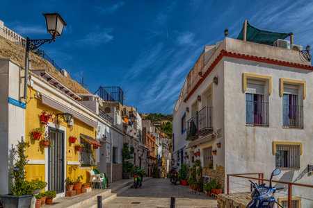 beautiful historic old colorful houses Barrio Santa Cruz Alicante Spain on a sunny dayの写真素材