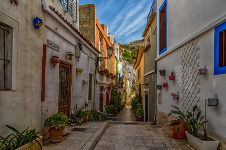 beautiful historic old colorful houses Barrio Santa Cruz Alicante Spain on a sunny dayの写真素材