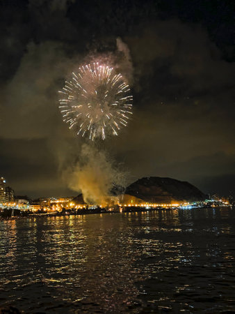 beautiful colorful fireworks in the night sky on the seafront of Alicante spainの写真素材